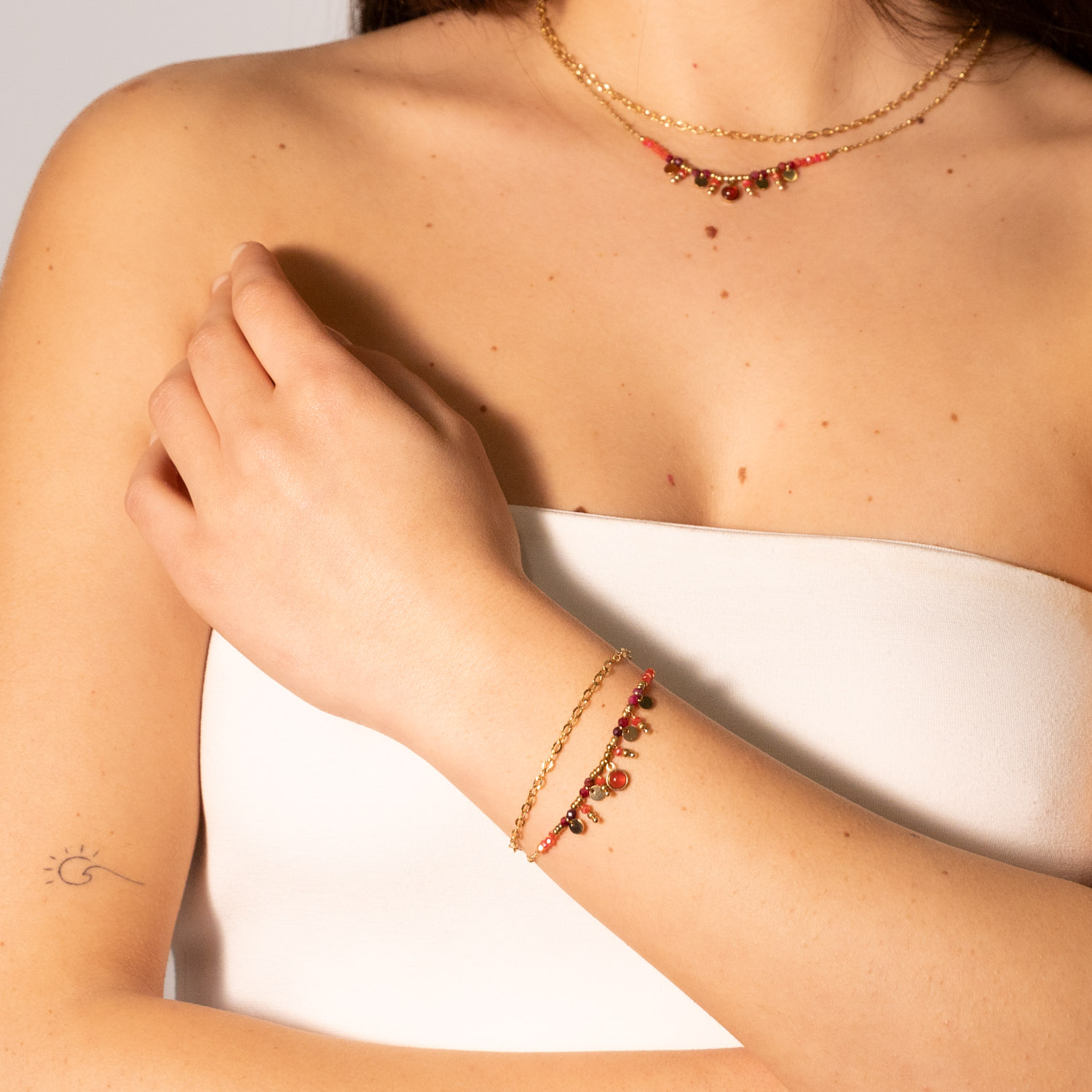 Bracciale due catene acciaio dorato pietrine rosse